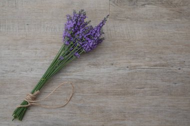 Freshly cut lavender bouquet displayed on a wooden table, creating a serene and aromatic scene