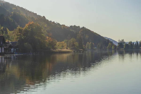 stock image Sunrise frames at the lake houses on the alpsee lake in the bavaria region of germany