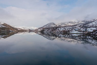 snowy mountains and blue sky with reflection in lake shot in winter season