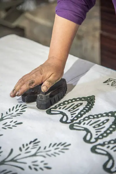 Womans hand working with fabric printing mold and ink traditional writing and woodblock printing work of Kastamonu and Anatolia region.