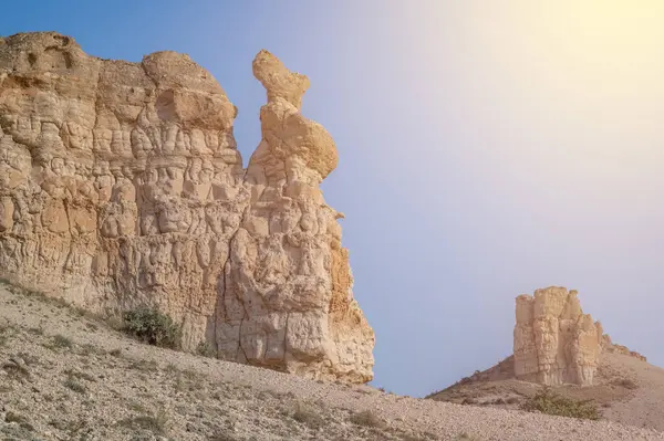 stock image Unique rock forms in the middle of deserted nature with sunset colors and clouds in the sky and sun light