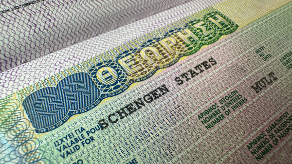 Close up detail of Greece visa fixed to passport EU Schengen