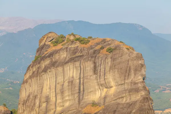 stock image Monasteries located on unique rock formations in the Meteora region of Greece are illuminated by the sunrise light.