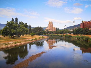 View of the city and the river with reflection clipart