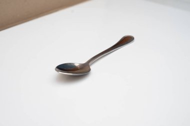 Beyaz bir zemine yerleştirilmiş bir kaşık