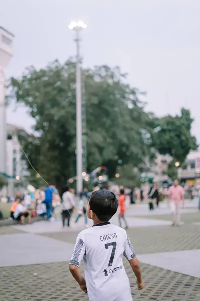 stock image Bogor, July 20 2024. A spacious city square with neatly arranged tiles and grass, where visitors enjoy a pleasant and well-maintained urban environment