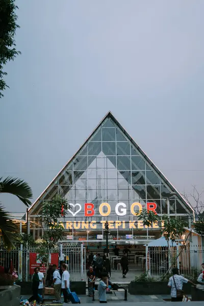 stock image Bogor, July 20 2024. A spacious city square with neatly arranged tiles and grass, where visitors enjoy a pleasant and well-maintained urban environment