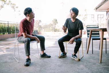 İki Güneydoğu Asyalı sohbet ediyor, bir anı yakalıyorlar