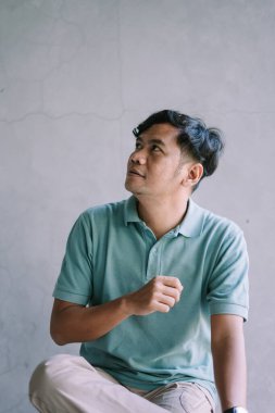 Sağına bakan Güneydoğu Asyalı bir adam, bir şeye odaklanmış, merak ya da ilgi çekiyor, yaşam tarzı, portre ve samimi an projeleri için mükemmel.