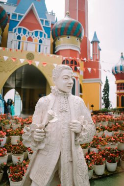 Bogor, September 2 2024. A statue of a man with a Disneyland-style castle in the background, creating a whimsical and enchanting scene clipart