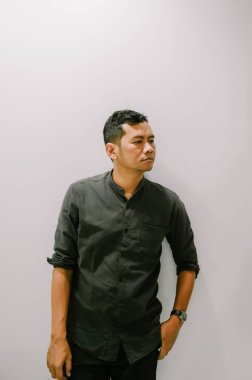 Saati olan düşünceli genç bir adam, düşünüyor..