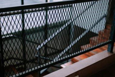 Modern bir binanın metal parmaklıklarına yakın çekim merdiveni. Soyut mimari arkaplan ögesi