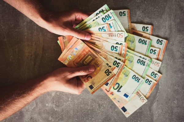 stock image Euro banknotes in man's hands