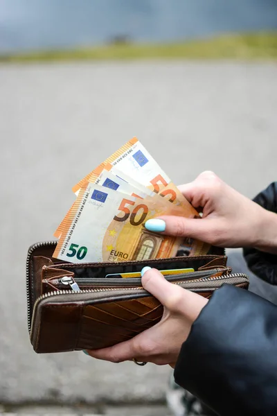 stock image Woman is taking money from the purse