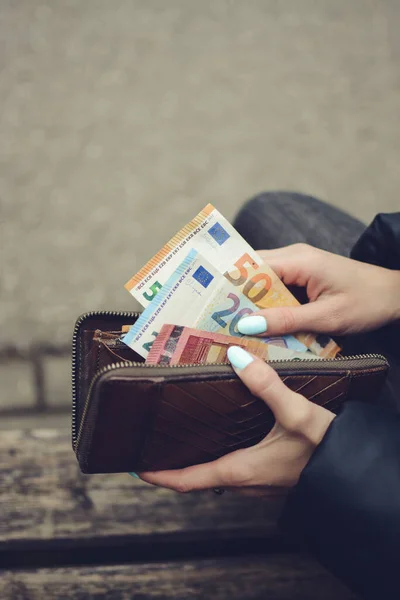 stock image Woman is taking money from the purse