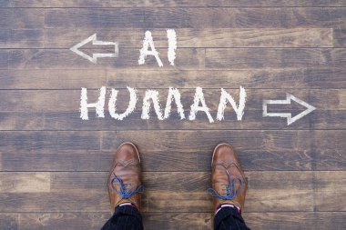 Man looking down at the words Artificial Intelligence - AI - and Human chalked onto the floor clipart