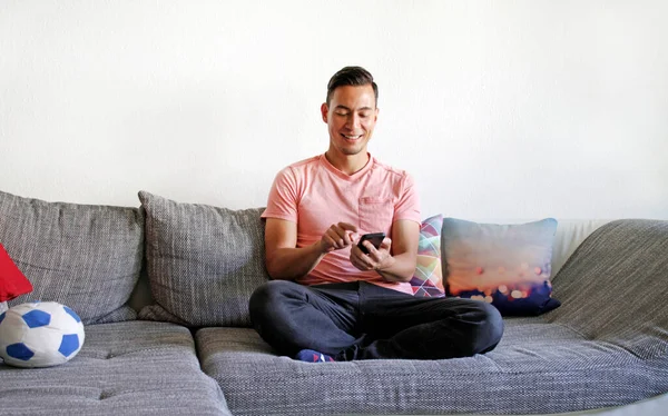 Smiling Man Handling Smartphone While Sitting Couch — Stock Photo, Image