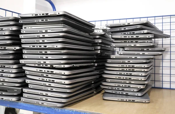 stock image Big stacks of discarded laptops, notebooks on a trolley