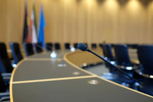 stock image Conference room with wooden walls and microphones at each seat