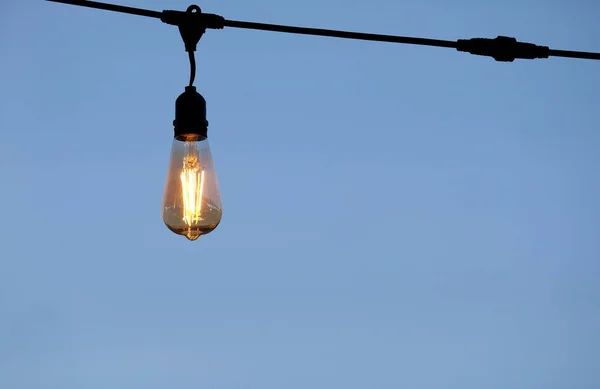 stock image Single light bulb against a clear sky