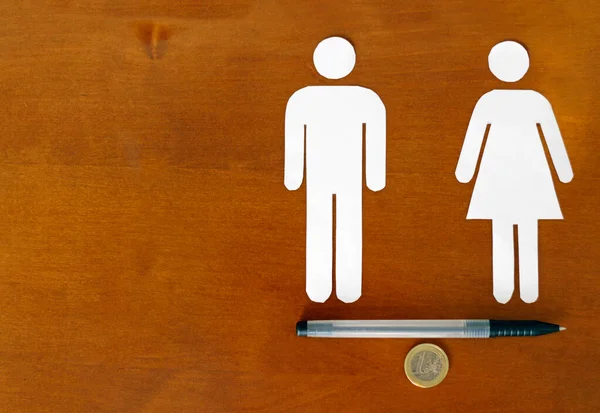 Gender equality - Overcoming the pay gap. Male and female symbol balancing on Euro coin