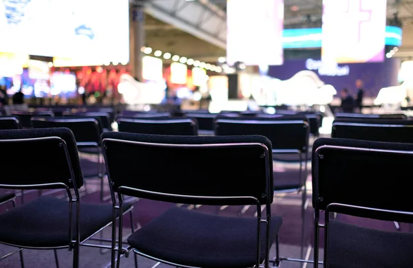 Rows of empty chairs at a conference before the event