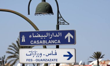 Road signs in Morocco pointing towards Casablanca and Fes clipart