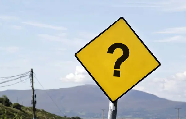 Yellow road sign with a question mark