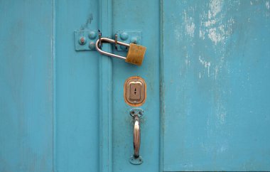 Turkuaz ahşap kapı ve asma kilit.