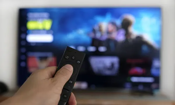 Remote control and screen - binge watching the favorite TV show