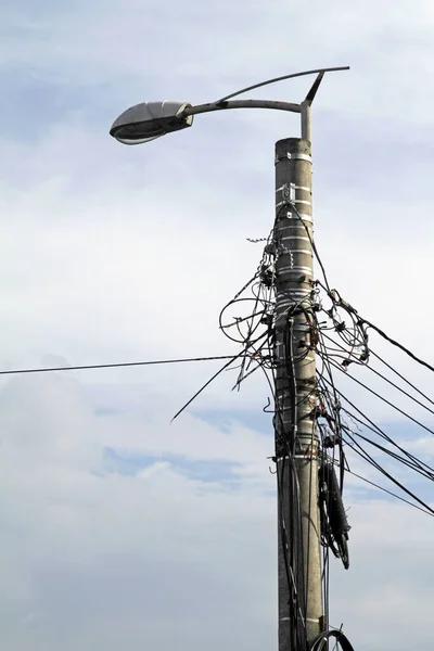 Entangled power lines attached to a street light in Romania
