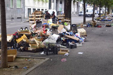 Garbage, boxes, crates left after the market on the street clipart