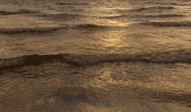 Baltık Denizi 'nin kumlu sahilinde dalgalar.