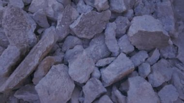 Day pan on a destructed road with large broken stones pieces all along at a rural village area in Greece.