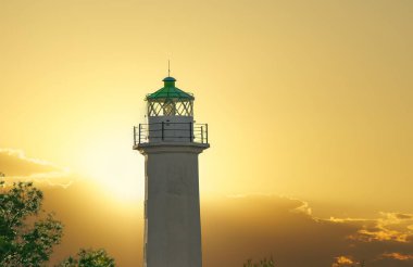 Lighthouse landscape shot against bright sunset in Greece. Evening view of phare beacon at Possidi Cape in Sithonia Chalkidiki peninsula.