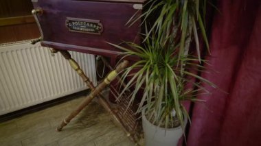 Thessaloniki, Greece - February 22 2023: Panning to 1918 music-producing barrel piano organ known as laterna or lantern inside a restaurant with vintage decoration.
