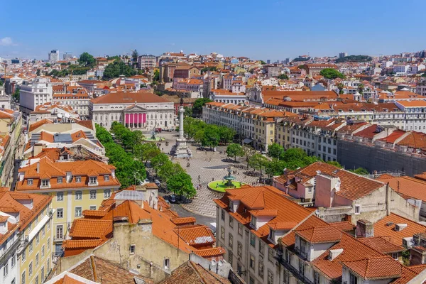 stock image Lisbon, Portugal panoramic landscape of Dom Pedro IV square, Praca Dom Pedro IV, with column surrounded by traditional low-rise red tile rooftop buildings and Teatro Nacional D. Maria II.