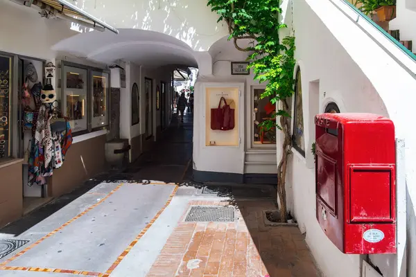 Stock image Capri, Italy - June 12 2024: Traditional alley with shops and post office red box in the capital town of Capri Island.