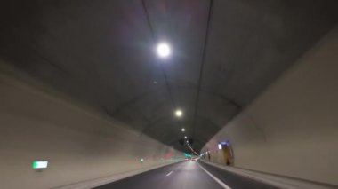 POV, Yunanistan 'ın Ege Otoyolu' ndaki çok şeritli bir tünel yolunda araba sürüşünün ön görüntüsü.