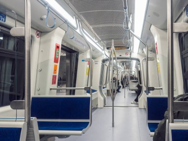 Selanik, Yunanistan - 9 Aralık 2024: Şehir toplu taşımacılığını temsil eden bazı boş koltuklar ve modern tasarım ile iyi ışıklandırılmış ve temiz metro içi.