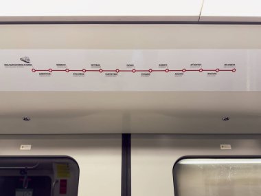 Thessaloniki, Greece - December 21 2024: Modern Metro Train Interior Featuring Subway Route Map in Greek and English. clipart