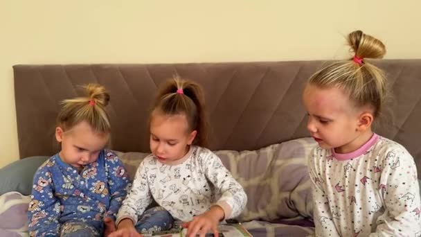 Siostry Trojaczki Czytają Razem Książkę Siedząc Łóżku Noszą Piżamę Wysokiej — Wideo stockowe