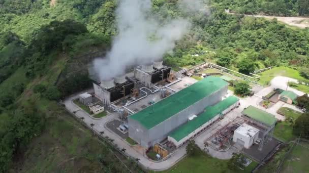 在丛林中的一座火山上的火力发电厂 蒸汽从大管子中升起 涡轮机旋转 热带岛屿 无人驾驶飞机拍摄 — 图库视频影像
