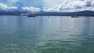 Bais Filipinler 'in beyaz kumları tropikal dağ adaları arasında gelgit oluşturur mavi okyanus tekneleri dağlar bulutlar