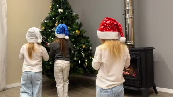 Three Little Sisters Triplets Decorate Christmas Tree Toys Garlands Children — Stock Video