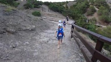Çocuklu bir aile Kırım 'daki Golitsyn patikasında yürüyor. Yüksek kalite 4k görüntü