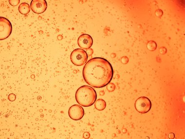 Kırmızı arkaplanda yağ baloncukları yakın çekim makrosu