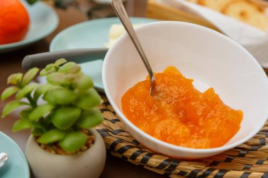 Homemade breakfast with pineapple butter, coffee and juice in the outdoor area in the morning