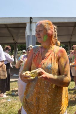 İnsanlar Hint festivalinde eğleniyor ve renkler sergiliyor.