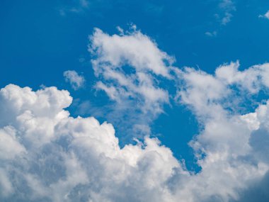 Mavi gökyüzünde beyaz bulutlar, doğa arka planı.